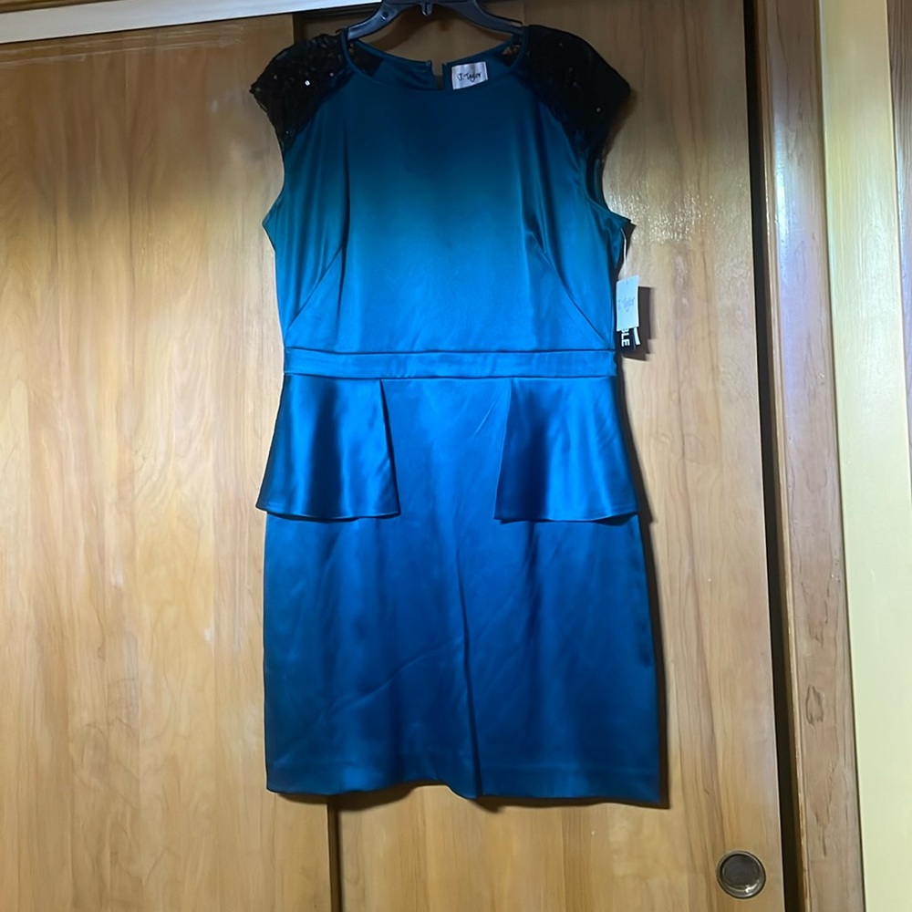 Teal dress with black lace cap sleeves front back flap.